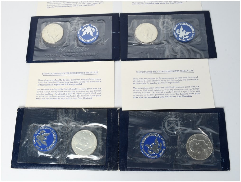 Four 1971-S US Eisenhower 40% Silver Dollar Uncirculated Coins in Original Mint Packaging: This lot contains four 1971-S Eisenhower silver dollar coins, struck in 40% silver at the San Francisco Mint. Each coin is in uncirculated condition and is housed in its original US Mint heat-sealed c