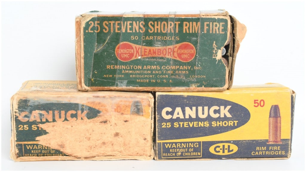 A Lot of 95 Rounds of Remington and Canuck .25 Stevens Short Rimfire Ammunition: This lot consists of a collection of 95 rounds of .25 Stevens Short rimfire ammunition, accompanied by three vintage cardboard boxes. The grouping includes one green Remington Kleanbore box and two ye