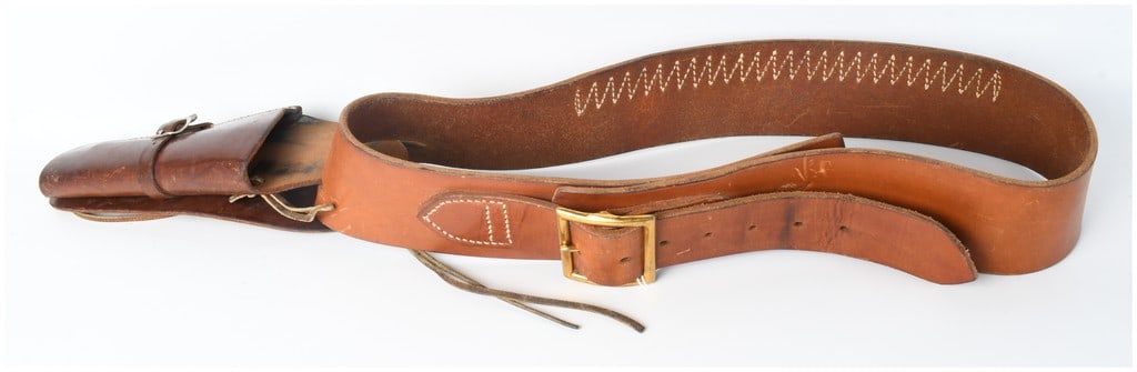 Sears Roebuck and Co. Model 10768 Buscadero Holster and Cartridge Belt Rig: This Western-style drop-loop buscadero leather gun belt and holster rig is constructed from durable brown leather. The belt features a row of 25 integrated cartridge loops suited for centerfire revolv