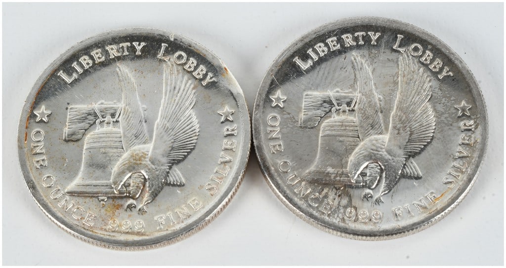 A Pair of Liberty Lobby 1 oz .999 Fine Silver Trade Unit Rounds: A pair of vintage silver bullion rounds issued by the Liberty Lobby and associated with the International Silver Trade Unit. Each round is struck from one troy ounce of .999 fine silver. The obverse f