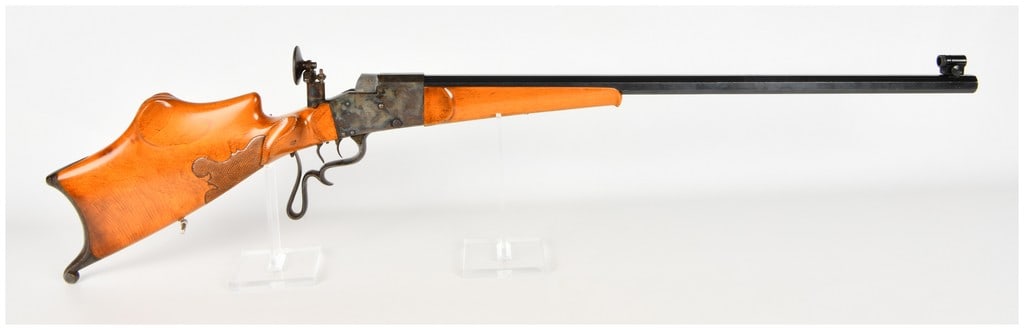 C.G. Haenel Schuetzen Falling Block Single Shot Rifle with Octagonal Barrel Antique: This C.G. Haenel single shot Schuetzen target rifle is built on a Martini-style falling block lever action. The firearm features a heavy octagonal barrel finished in a deep blue, paired with a receive