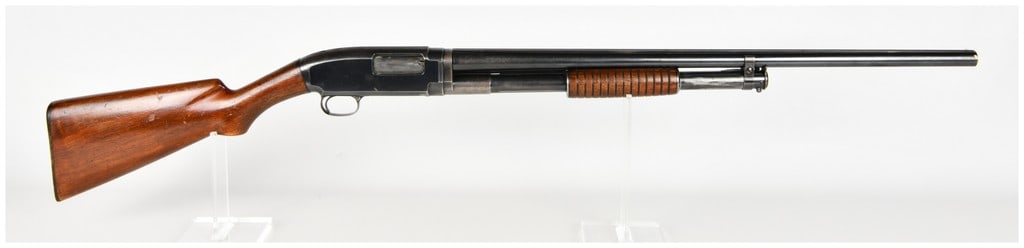 Winchester Model 12 Pump Action Shotgun 16 Gauge 1915: This Winchester Model 12 is a pump-action shotgun chambered in 16 gauge, featuring a barrel equipped with a factory-style solid sighting rib. The firearm is constructed with a blued steel receiver and