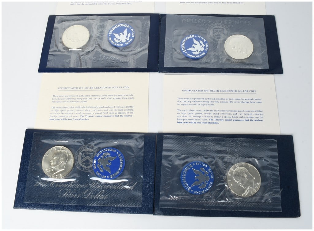 A Set of 4 US 1971-1974-S Eisenhower 40% Silver Dollars in Original Blue Pack Packaging: A set of 4 United States uncirculated Eisenhower Dollars struck at the San Francisco Mint between 1971 and 1974. The lot includes one coin for each year: 1971-S, 1972-S, 1973-S, and 1974-S. These coin