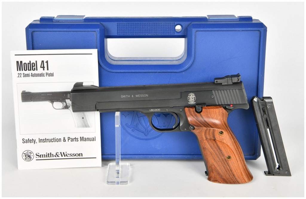 Smith & Wesson Model 41 Semi-Automatic Pistol .22 Long Rifle with 5.5 Inch Barrel: This Smith & Wesson Model 41 is a high-precision semi-automatic target pistol chambered for the .22 Long Rifle cartridge. It is configured with a 5.5 inch barrel featuring a full-length serrated top r