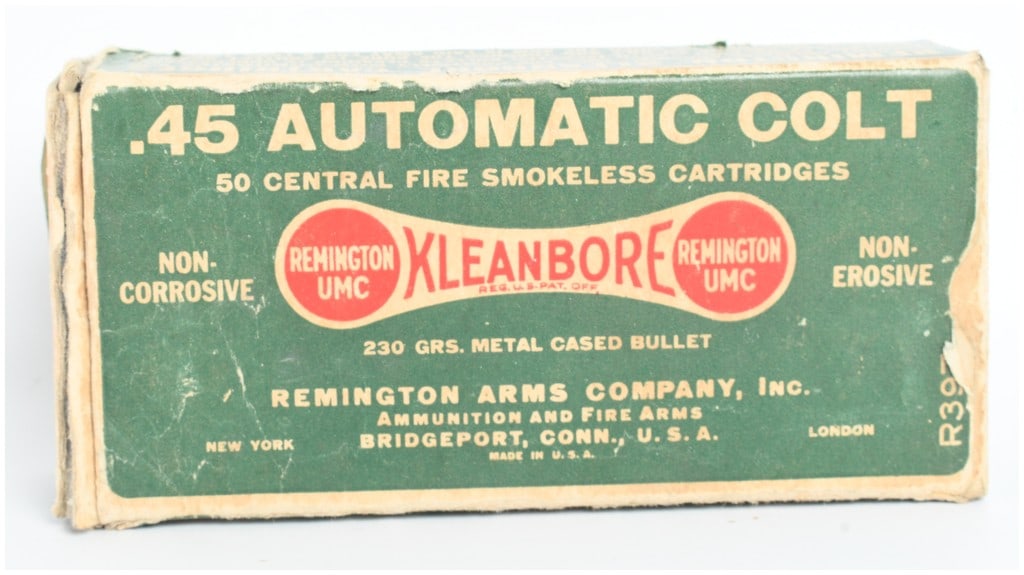 A Lot of 50 Remington Kleanbore Ammunition .45 Automatic Colt: This lot consists of an original Remington Arms Company, Inc. Kleanbore cardboard ammunition box containing a mixed collection of 50 cartridges in .45 caliber. The two-piece green and red box is label