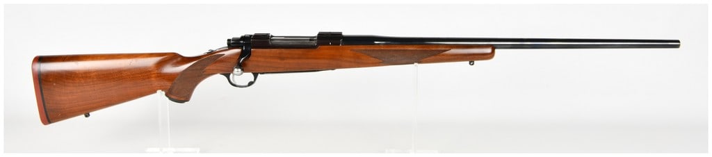 Ruger M77 Bolt Action Rifle .25-06 with 24 Inch Barrel: This is a Ruger M77 bolt action rifle chambered in .25-06 Remington. It features a 24-inch blued barrel and a receiver with integral scope mount bases. This example is an early tang safety model, iden