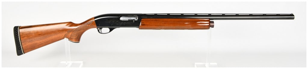Remington Model 1100 Semi-Automatic Shotgun 12 Gauge with 26 Inch Barrel: This is a Remington Model 1100 semi-automatic shotgun chambered for 12 gauge 2 3/4 inch or shorter shells, optimized for field use. The firearm features a 26 inch blued steel barrel equipped with a ve