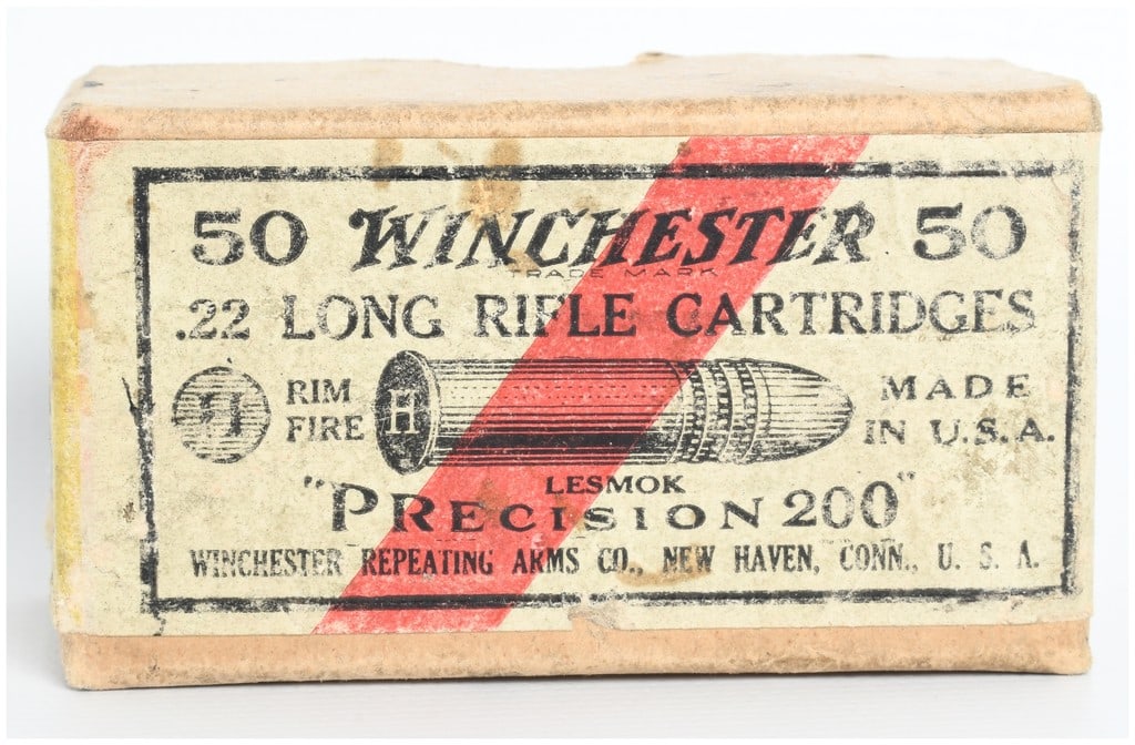 Winchester Precision 200 Rimfire Ammunition .22 Long Rifle Lot of 50 Rounds: This lot comprises a vintage two-piece cardboard box containing 50 rounds of Winchester Repeating Arms Co. .22 Long Rifle Precision 200 Lesmok rimfire cartridges. The ammunition is packaged in a tradi
