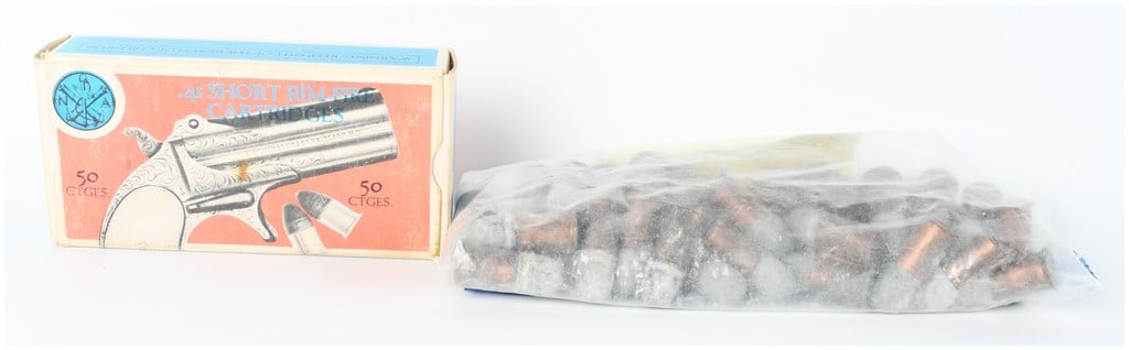 A Lot of 70 Navy Arms Co. .41 Short Rimfire Cartridges: This lot consists of a collection of 70 rounds of .41 Short Rimfire ammunition produced for the Navy Arms Co. The ammunition features copper casings and lead round-nose bullets. The lot includes an or