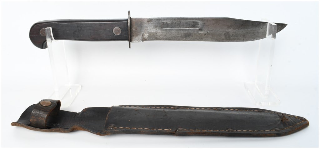Antique Clip-Point Fighting Knife and Hand-Stitched Leather Scabbard: This is an antique clip-point fighting knife and coordinating scabbard, showing design characteristics consistent with theater-made or private purchase combat knives of the late 19th to early 20th cen