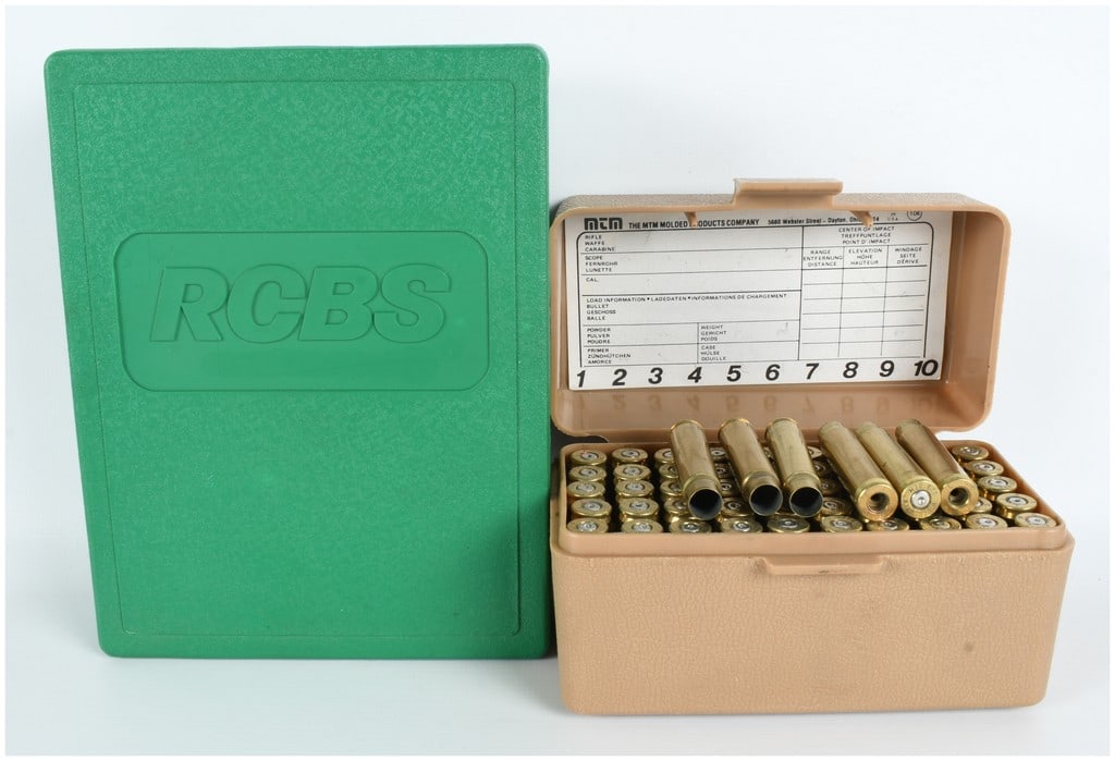 RCBS 7mm TCU Full Length Two-Die Set with 56 Count of Empty Brass Casings: This lot features a complete RCBS full-length two-die reloading set chambered for 7mm TCU, accompanied by a collection of 56 pieces of empty brass casings for reloading. The die set is contained in it