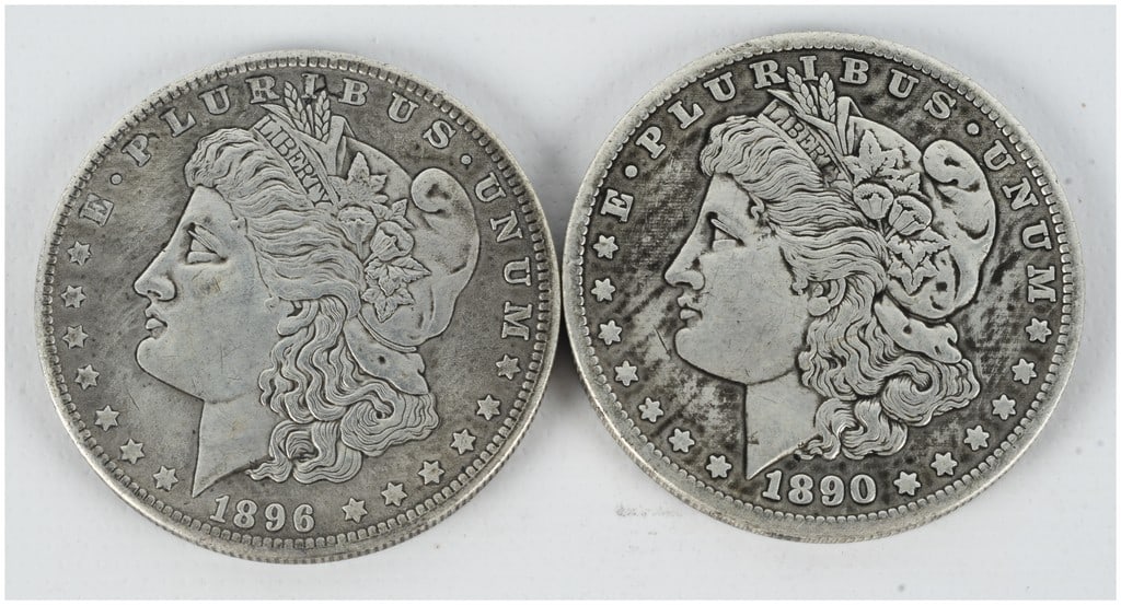 A Pair of US Morgan Silver Dollars, 1890-S and 1896: A pair of US Morgan silver dollars. One coin is dated 1896 and was struck at the Philadelphia mint. The second coin is dated 1890 and features an S mint mark on the reverse, indicating production at t