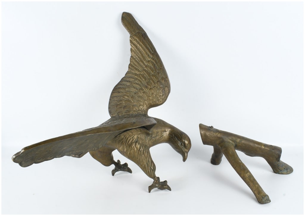 Vintage Cast Brass Eagle on Branch Sculpture: This cast brass sculpture depicts an eagle in a dynamic descending pose with its wings spread and talons extended forward as if landing. The work is composed of two separate cast metal components: the
