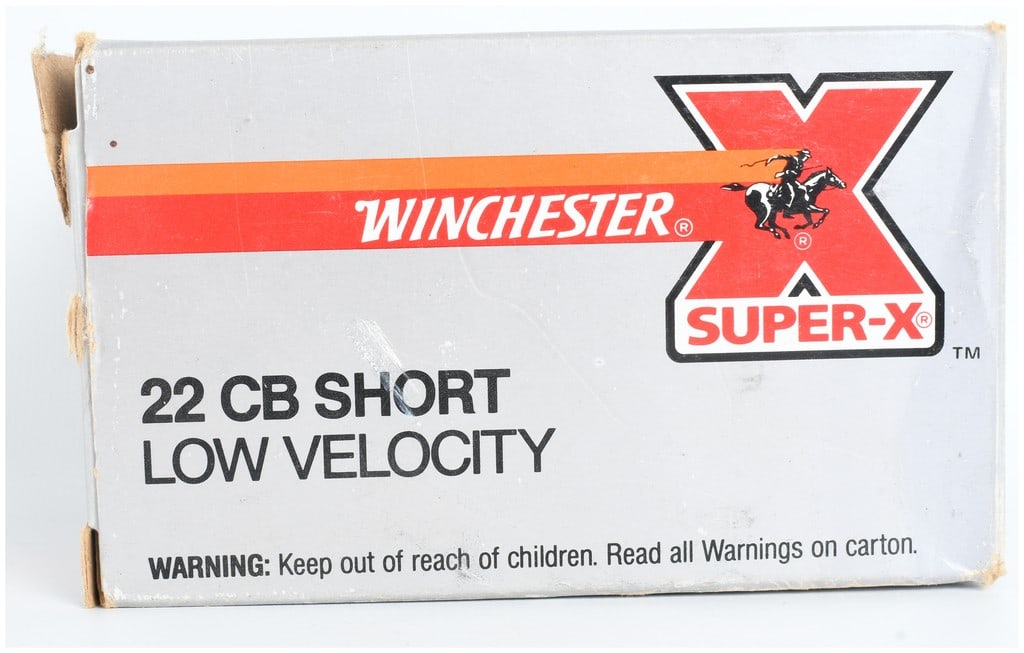 A Lot of 250 Rounds of Winchester Super-X .22 CB Short Rimfire Ammunition: This lot consists of five individual boxes of Winchester Super-X .22 CB Short Low Velocity rimfire ammunition, totaling 250 rounds. The ammunition is housed in grey cardboard packaging featuring the r