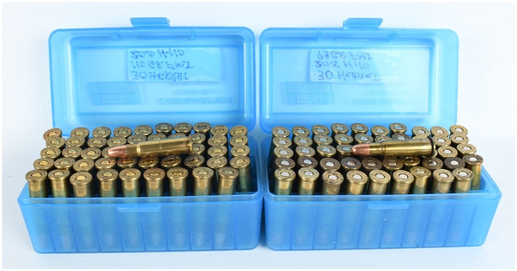 A Lot of 100 Rounds of Remanufactured .30 Herrett Centerfire Rifle Ammunition: This lot consists of 100 rounds of remanufactured .30 Herrett centerfire rifle ammunition, contained within two blue plastic MTM Case-Gard storage boxes. The ammunition is a wildcat cartridge typicall