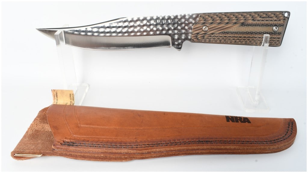 Silver Stag Friends Of NRA Fixed Blade Knife D2 Tool Steel: This Silver Stag fixed blade knife features a clip point blade crafted from D2 tool steel and was produced as a commemorative item for the Friends of NRA. The blade exhibits a decorative engine turned