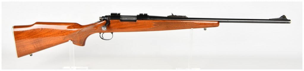 Remington Model 700 Bolt Action Rifle .243 Win: Remington Model 700 bolt action sporting rifle chambered in .243 Winchester. The firearm features a blued steel barrel fitted with a ramped front sight containing a gold-colored bead and an adjustable