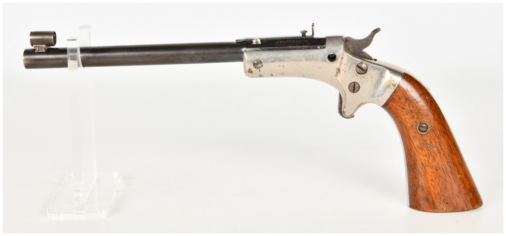 J. Stevens Arms & Tool Co. No. 35 Offhand Tip-Up Single Shot Target Pistol .22 Caliber with 10 Inch: This is a single-shot tip-up target pistol chambered for .22 caliber rimfire cartridges, configured as a Stevens No. 35 Offhand model. The firearm features a 10-inch round barrel with a thinned blued 