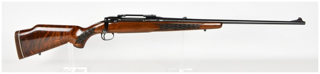 Savage Model 110D Series H Bolt Action Rifle 7mm Remington Magnum with 24 Inch Barrel: This Savage Model 110D Series H is a bolt-action sporting rifle chambered in 7mm Remington Magnum, intended for large game hunting. It features a 24 inch blued barrel fitted with an adjustable folding