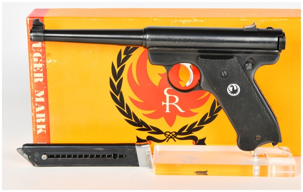 Ruger Mark I Semi-Automatic Pistol .22 LR with 6 Inch Tapered Barrel: This semi-automatic pistol is a Ruger Mark I chambered in .22 Long Rifle. It is equipped with a 6-inch tapered barrel featuring a fixed front blade sight and a fixed rear notch sight. The firearm exhi