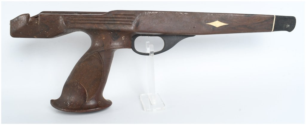 Remington XP-100 Zytel Nylon Pistol Stock: Identified as a factory synthetic stock for a Remington XP-100 bolt-action pistol, this component is constructed from marbled brown Zytel nylon. The stock features a specialized target-style pistol gr