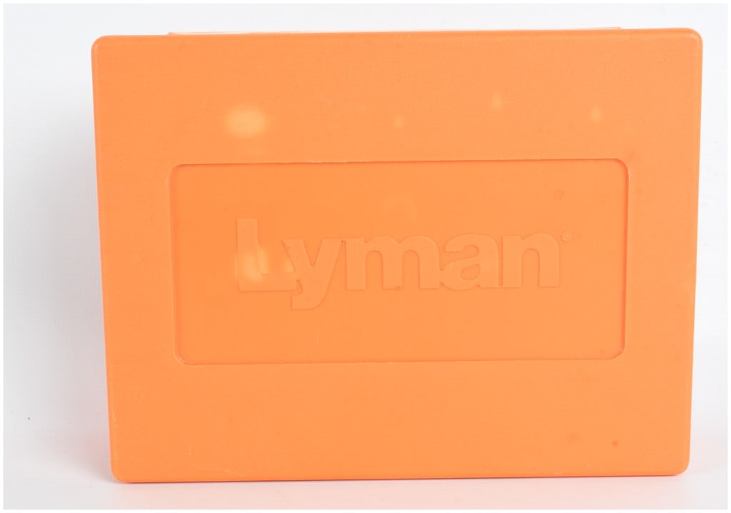 A Trio of Mixed Lyman and Lee Reloading Dies for 7-30 Waters in Lyman Case: This lot features a mixed three-piece reloading die set chambered for 7-30 Waters, organized within a signature orange Lyman plastic storage case. The set includes a variety of manufacturers, featurin
