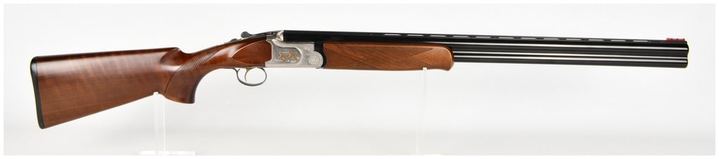 Mossberg International Silver Reserve Over-And-Under Shotgun 12 Gauge with 28 Inch Barrels: This is a Mossberg International Silver Reserve over-and-under break-action shotgun chambered for 12 gauge 2 3/4 inch and 3 inch shells. The firearm features blued barrels with a ventilated top rib an