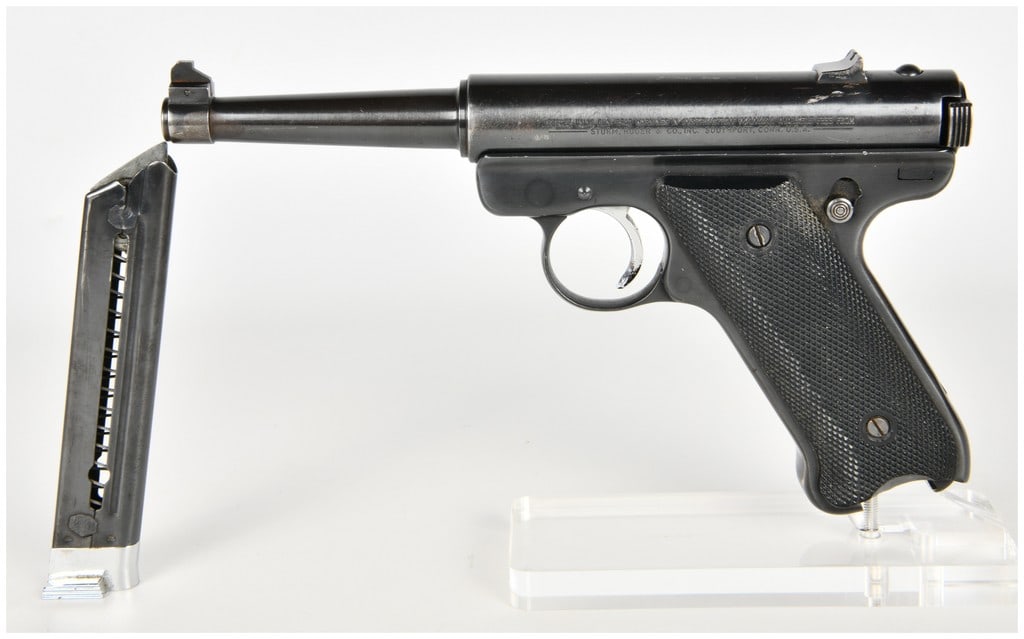 Ruger Standard Semi-Automatic Pistol .22 Long Rifle with 4.75 Inch Barrel: This Ruger Standard semi-automatic pistol is chambered in .22 Long Rifle and is configured with a 4.75-inch tapered barrel. The firearm features a blued steel finish on the barrel and receiver. It is 