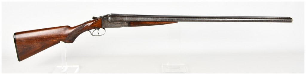Ithaca Gun Company Boxlock Side-by-Side Shotgun 12 Gauge: This Ithaca Gun Company side-by-side break-action shotgun is chambered in 12 gauge and features a classic boxlock action. The barrels are constructed of patterned Damascus steel and are equipped with 