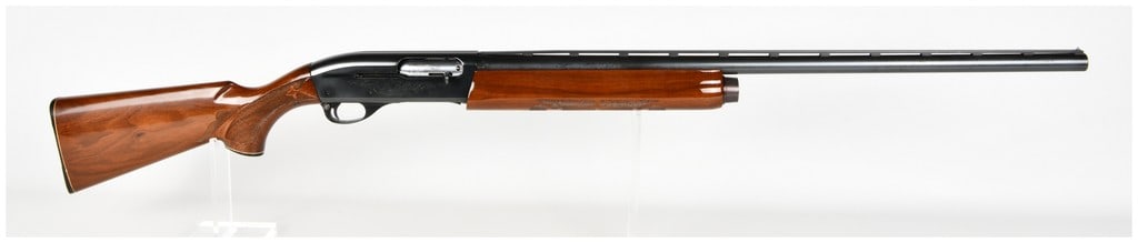 Remington Model 1100 Semi-Automatic Shotgun 12 Gauge with Ventilated Rib Barrel: This Remington Model 1100 is a gas-operated semi-automatic shotgun chambered for 12 gauge, designed for versatility in the field or at the range. The firearm is equipped with a blued steel barrel feat