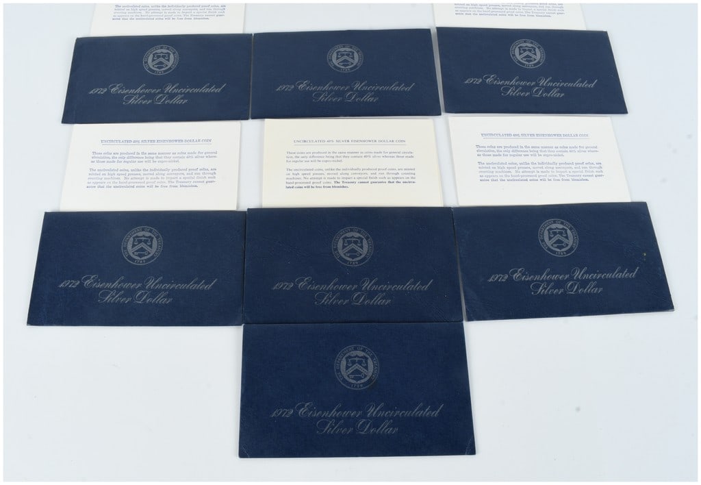 Seven US 1972 Eisenhower Silver Dollar Empty Sleeves with COAs: A collection of seven official United States Department of the Treasury presentation envelopes and informational cards for the 1972 Eisenhower uncirculated silver dollar. This lot consists of 7 empty 