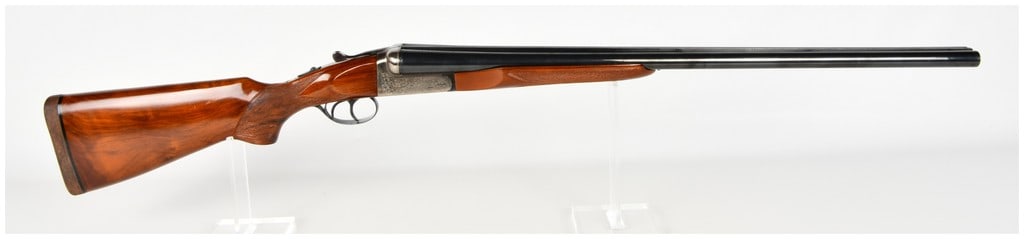 Churchill Windsor I Side-By-Side Shotgun 12 Gauge with 27.5 Inch Barrel: This Churchill Windsor I is a side-by-side break-action shotgun chambered for 12-gauge shells with 3-inch magnum chambers. It features 27.5-inch barrels with a polished blued finish, joined by a matte