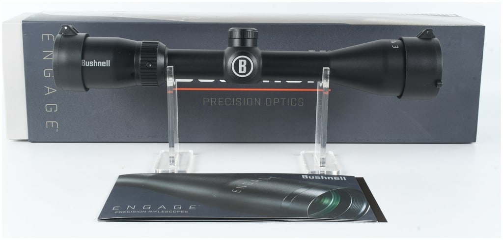 Bushnell Engage 3-9x40mm Riflescope with Deploy MOA Reticle: This Bushnell Engage precision riflescope features a matte black finish. The ocular bell is marked Bushnell and the objective bell is marked ENGAGE. The magnification adjustment ring is graduated from