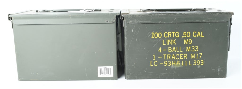 A Pair of US Military M2A1 .50 Caliber Steel Ammunition Cans: This lot features two United States military surplus M2A1 steel ammunition storage containers, specifically designed for .50 caliber ammunition. One container retains its original yellow stenciled mar