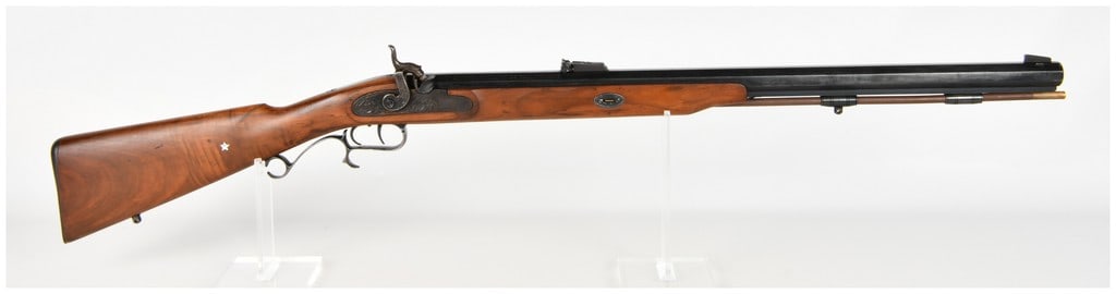 Thompson Center Arms Renegade Percussion Muzzleloading Rifle .54 Caliber with Octagonal Barrel: This Thompson Center Arms Renegade is a .54 caliber percussion muzzleloading rifle designed with a robust octagonal blued barrel and double-set triggers. The rifle features a scroll-engraved lock plat