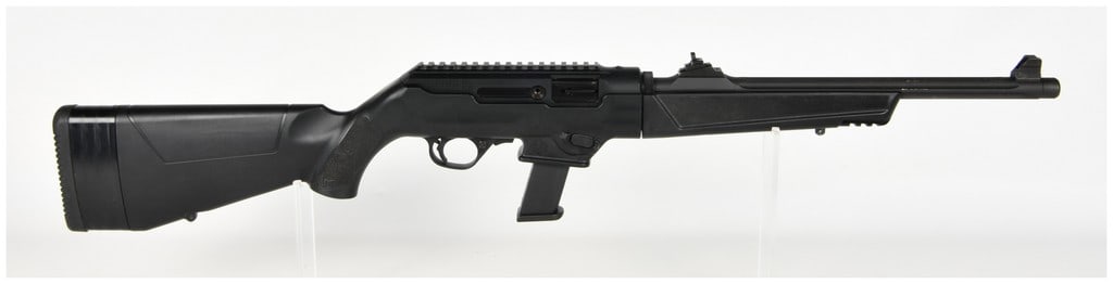 Ruger PC Carbine Semi-Automatic Rifle .40 S&W with 16.12 Inch Barrel: This is a Ruger PC Carbine semi-automatic, takedown rifle chambered in .40 S&W. The firearm features a 16.12-inch heavy fluted barrel with a threaded muzzle and protector, paired with a matte black re