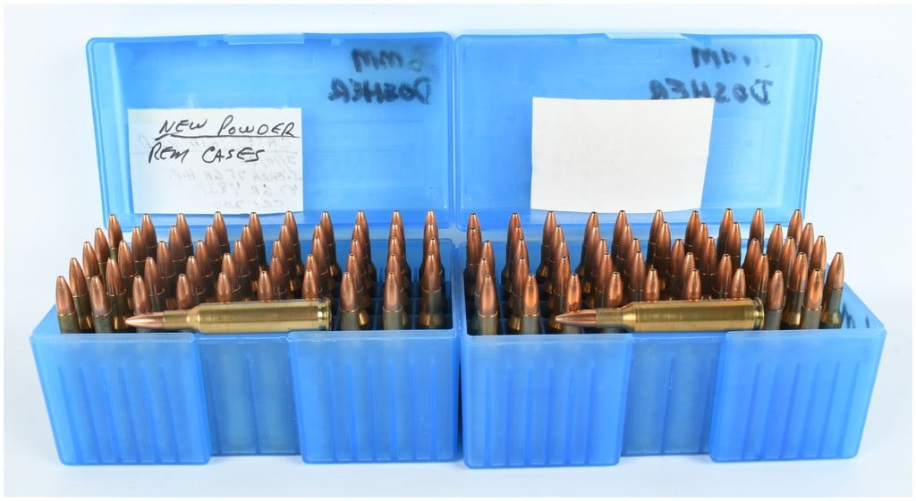 A Lot of 100 Rounds of 6mm Dasher Hand-Loaded Ammunition: This lot consists of 100 rounds of custom hand-loaded rifle ammunition chambered in the 6mm Dasher wildcat caliber. The cartridges are organized into two blue plastic MTM 50-round flip-top storage box