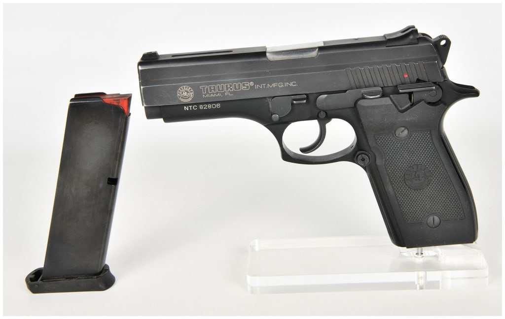 Taurus PT 945 Semi-Automatic Pistol .45 ACP with 4.25 Inch Barrel: This Taurus PT 945 is a semi-automatic, double-action/single-action pistol chambered in .45 ACP. The firearm is configured with a black blued finish on the slide and frame, featuring a 4.25-inch stain