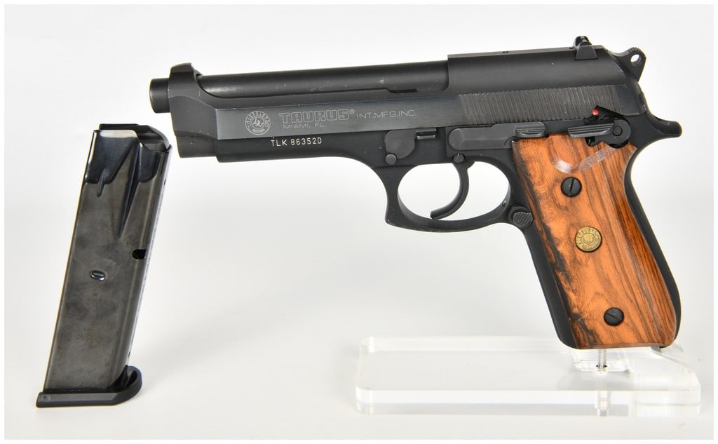 Taurus PT 92 AF Semi-Automatic Pistol 9mm Parabellum with 5 Inch Barrel: This is a Taurus Model PT 92 AF semi-automatic pistol chambered in 9mm Parabellum, featuring a 5 inch barrel and a traditional double-action/single-action operation. The firearm is finished in a matte