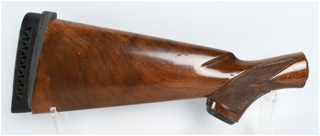 Winchester Model 1200 and 1400 Shotgun Buttstock 12 Gauge: This is a factory original Winchester buttstock designed for use with the Model 1200 and 1400 series of 12 gauge shotguns. Constructed from walnut, the stock features a high-gloss finish and textured