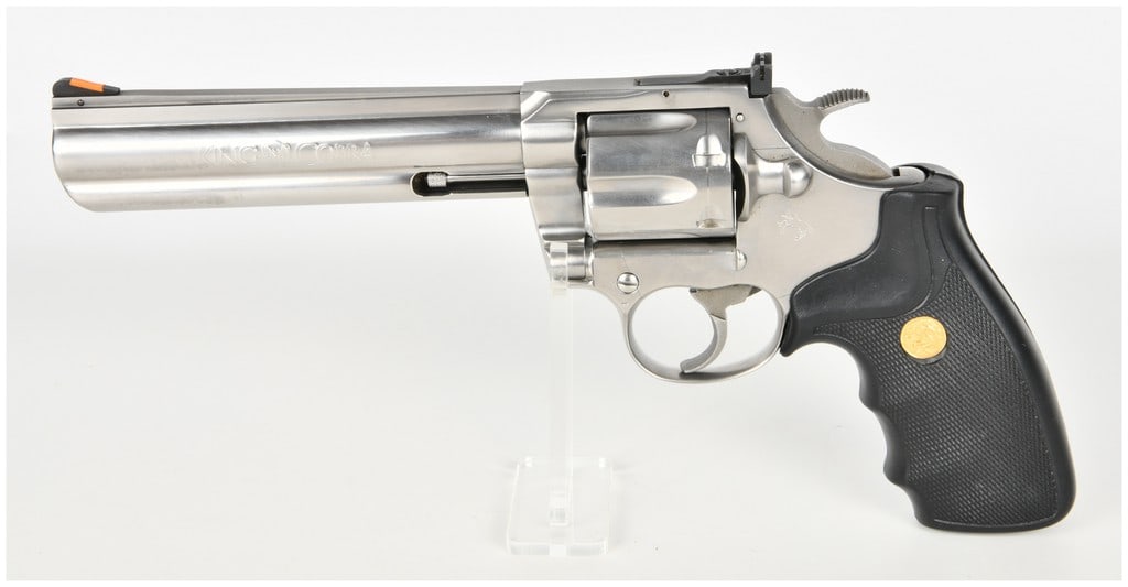 Colt King Cobra Double Action Revolver .357 Magnum with 6 Inch Barrel: This is a Colt King Cobra double-action revolver chambered in .357 Magnum. It features a 6-inch barrel equipped with a full-length underlug and a solid rib. The firearm is constructed with a brushed s