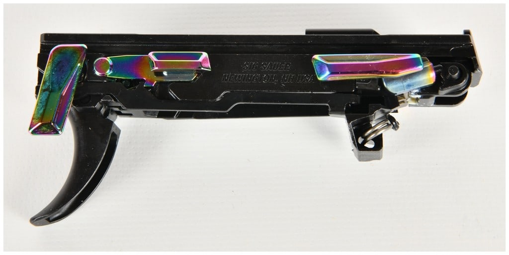 A Pair of Sig Sauer P320 Semi-Automatic Fire Control Units: This lot features a pair of Sig Sauer P320 modular fire control units (FCUs) designed as the serialized chassis for the P320 handgun platform. Each unit is constructed with a black frame and accented 