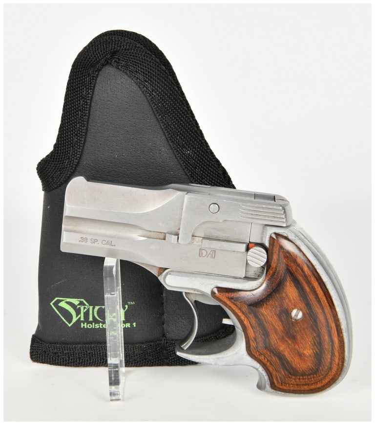 American Derringer Corp. DA38 Double-Action Over/Under Derringer .38 Special with 3.3 Inch Barrel: This American Derringer Corp. DA38 is a double-action over/under derringer chambered in .38 Special. The firearm features a 3.3 inch stainless steel barrel assembly with an integral front sight blade 