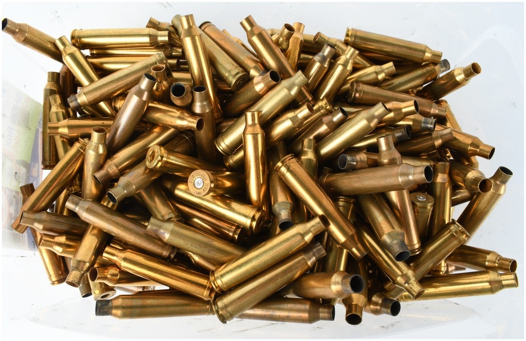 A Lot of 72 Spent Brass Rifle Ammunition Casings 7mm Remington Magnum: This lot comprises 72 spent brass rifle ammunition casings chambered for 7mm Remington Magnum. These components feature a belted, bottlenecked design typical of magnum rifle cartridges. The collection