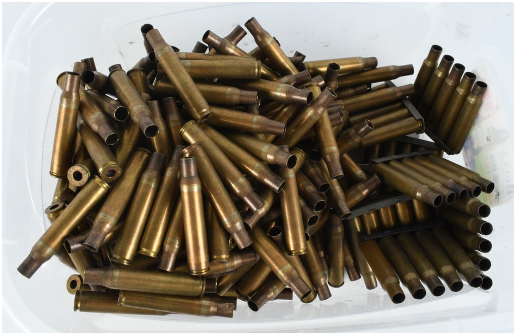 A Collection of 250 Frankford Arsenal 1959 .30-06 Springfield Match Grade Brass Shell Casings: This lot features a collection of 250 spent .30-06 Springfield match grade brass rifle shell casings. The assembly is comprised of 200 loose Frankford Arsenal casings and 50 casings organized on 5-rou
