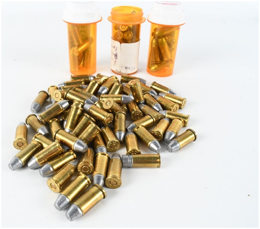 A Lot of 105 Rounds of Remanufactured .38 S&W and .32 S&W Long Ammunition: This lot consists of a group of 105 rounds of remanufactured handgun ammunition, featuring a mixture of .38 S&W and .32 S&W Long calibers. The collection is organized into a loose pile of 62 rounds an