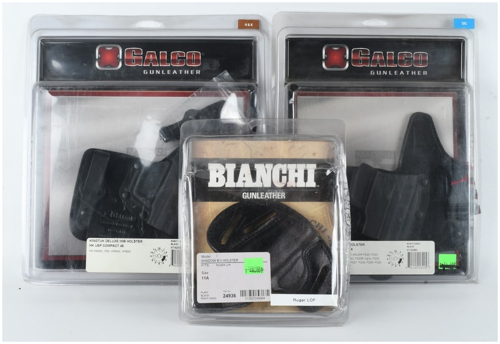 A Trio of Galco and Bianchi Handgun Holsters: A group of three handgun holsters in their original manufacturer retail packaging, including two inside the waistband (IWB) models and one outside the waistband (OWB) model. The first is a Galco Kingt