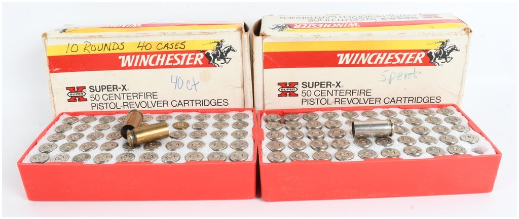 A Collection of 100 Winchester Super-X 38 Automatic Spent Ammunition Casings and Boxes: This lot consists of 100 spent ammunition casings organized within two red plastic trays with white foam inserts, accompanied by two vintage Winchester Super-X cardboard boxes. The casings are compris