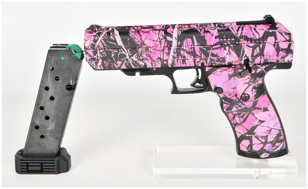 Hi-Point Firearms Model JHP Semi-Automatic Pistol .45 ACP with 4.5 Inch Barrel: This Hi-Point Firearms Model JHP is a semi-automatic pistol chambered in .45 ACP with a 4.5 inch barrel. The firearm features a pink and black camouflage finish applied over the slide and polymer fram