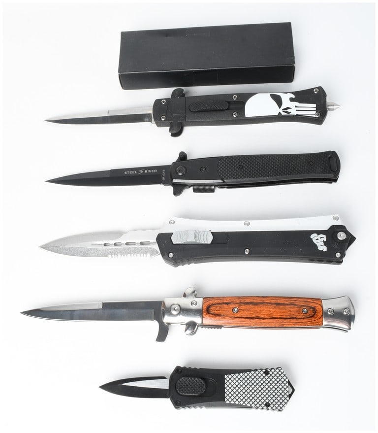 A Collection of 5 Assorted Automatic and Folding Pocket Knives: This collection consists of five assorted knives, including four automatic out-the-front and stiletto-style knives and one folding pocket knife. The first item is an out-the-front automatic knife feat